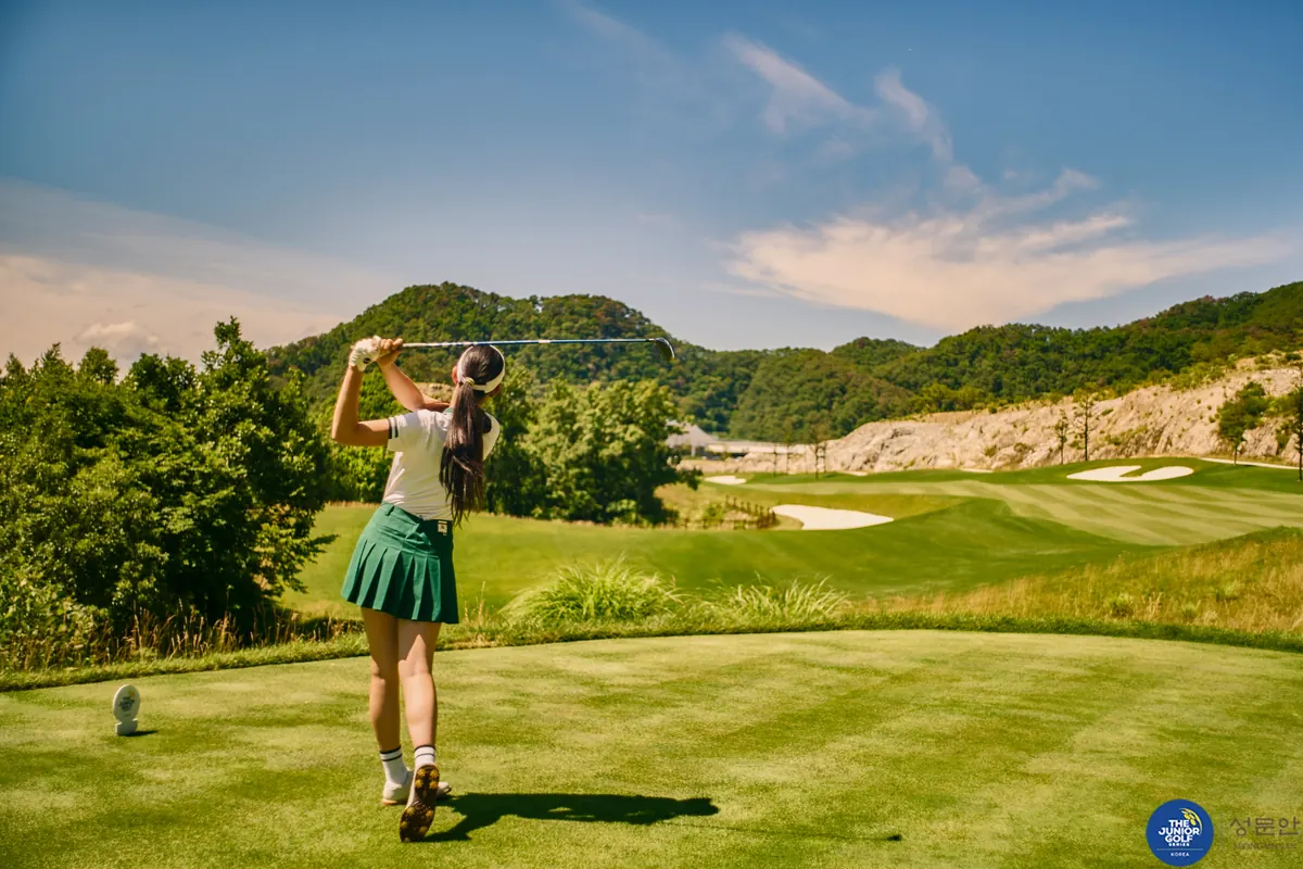 Junior golfer teeing off on a championship course at a JGS Korea series event