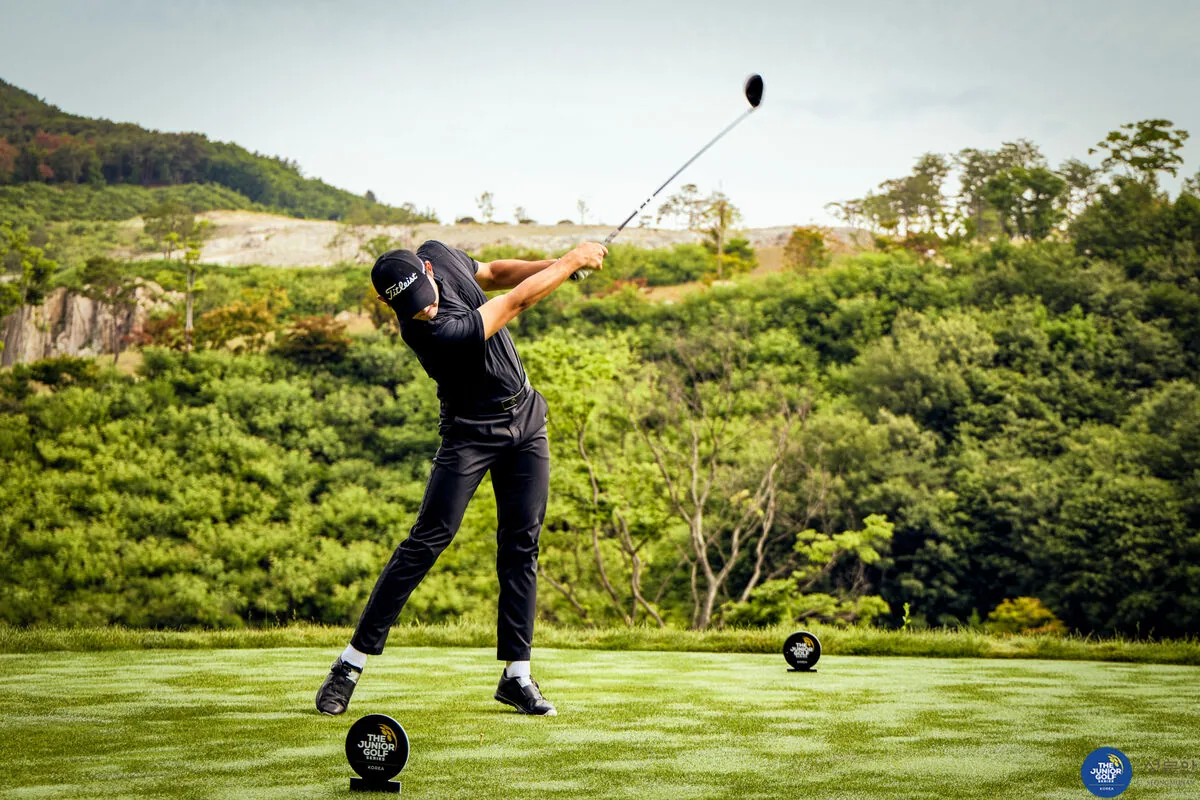 Junior golfer teeing off at an international course