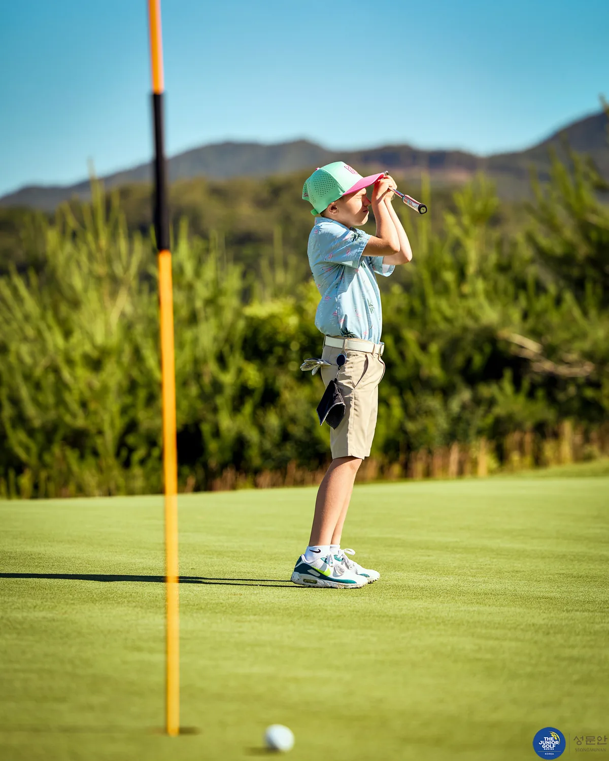 Junior golfer celebrating a made putt