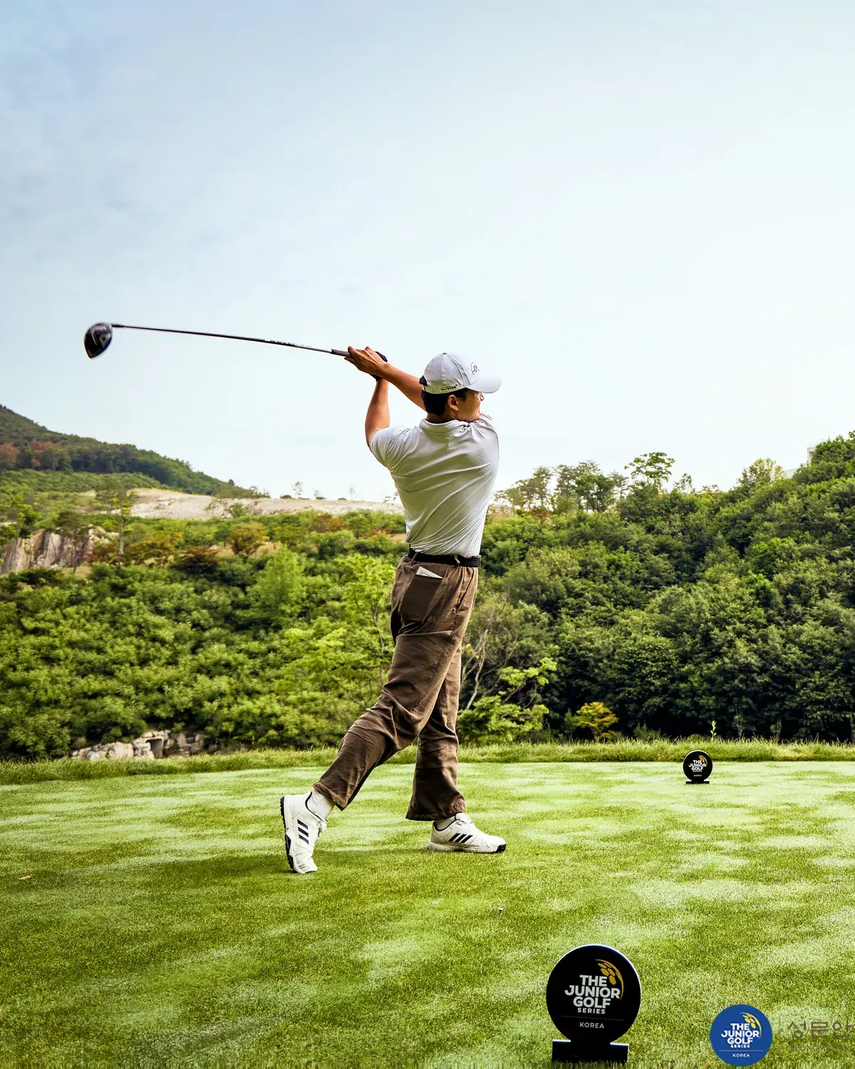 Junior golfer teeing off during the series